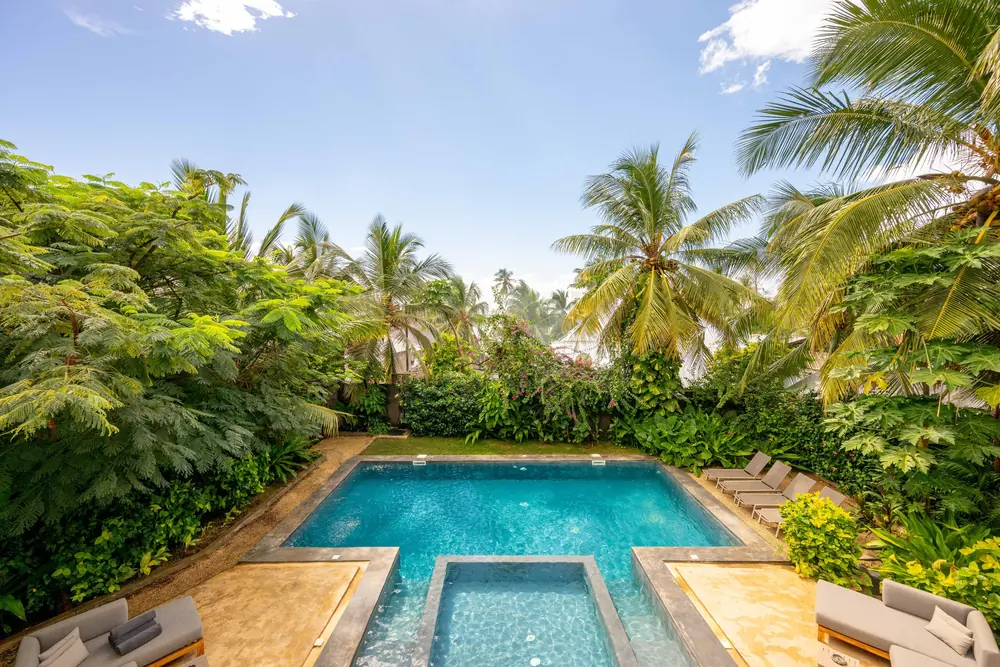 The pool enclosed by dense tropical planting