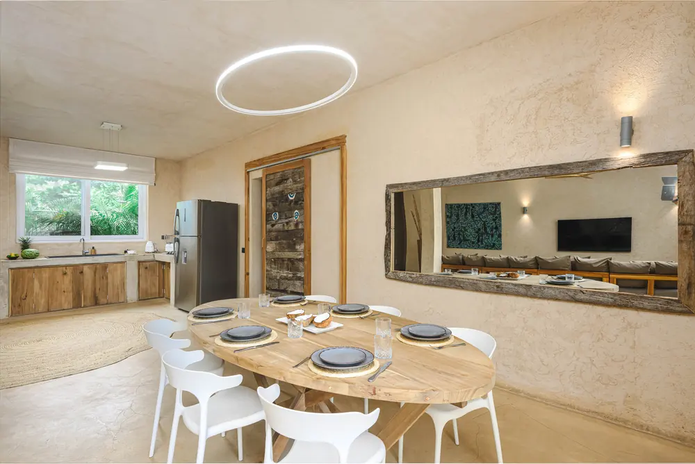 Dining table set beneath a circular pendant light