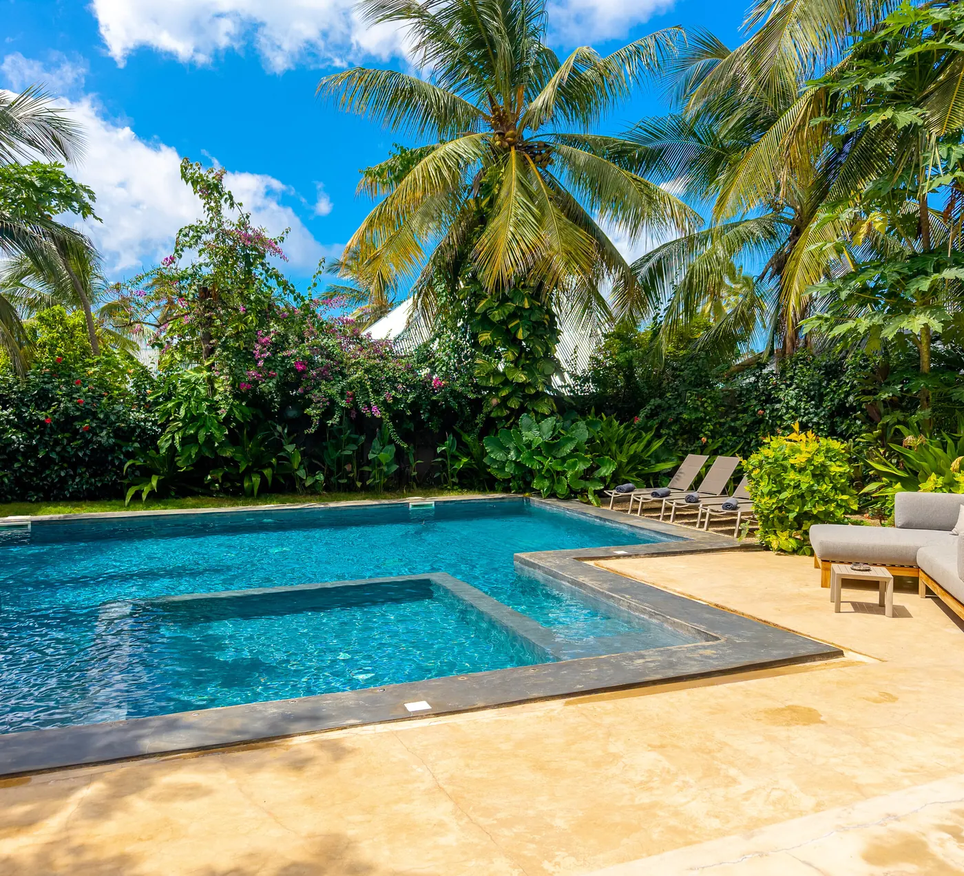 Sun loungers and daybeds along the pool at Villa Kokos