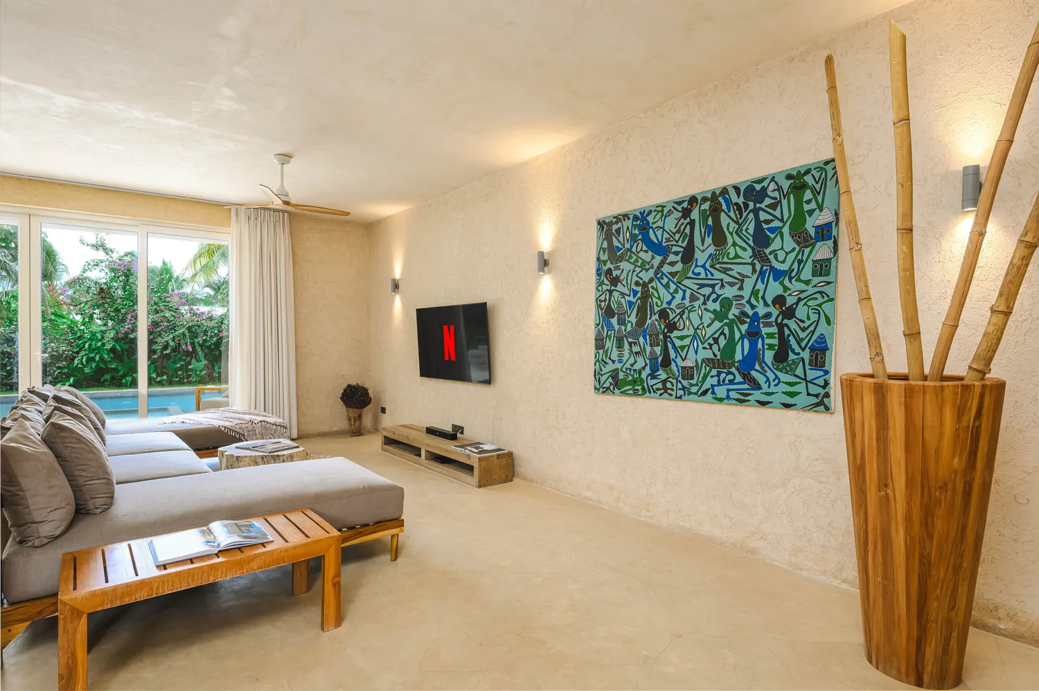 Living room with African artwork and garden view