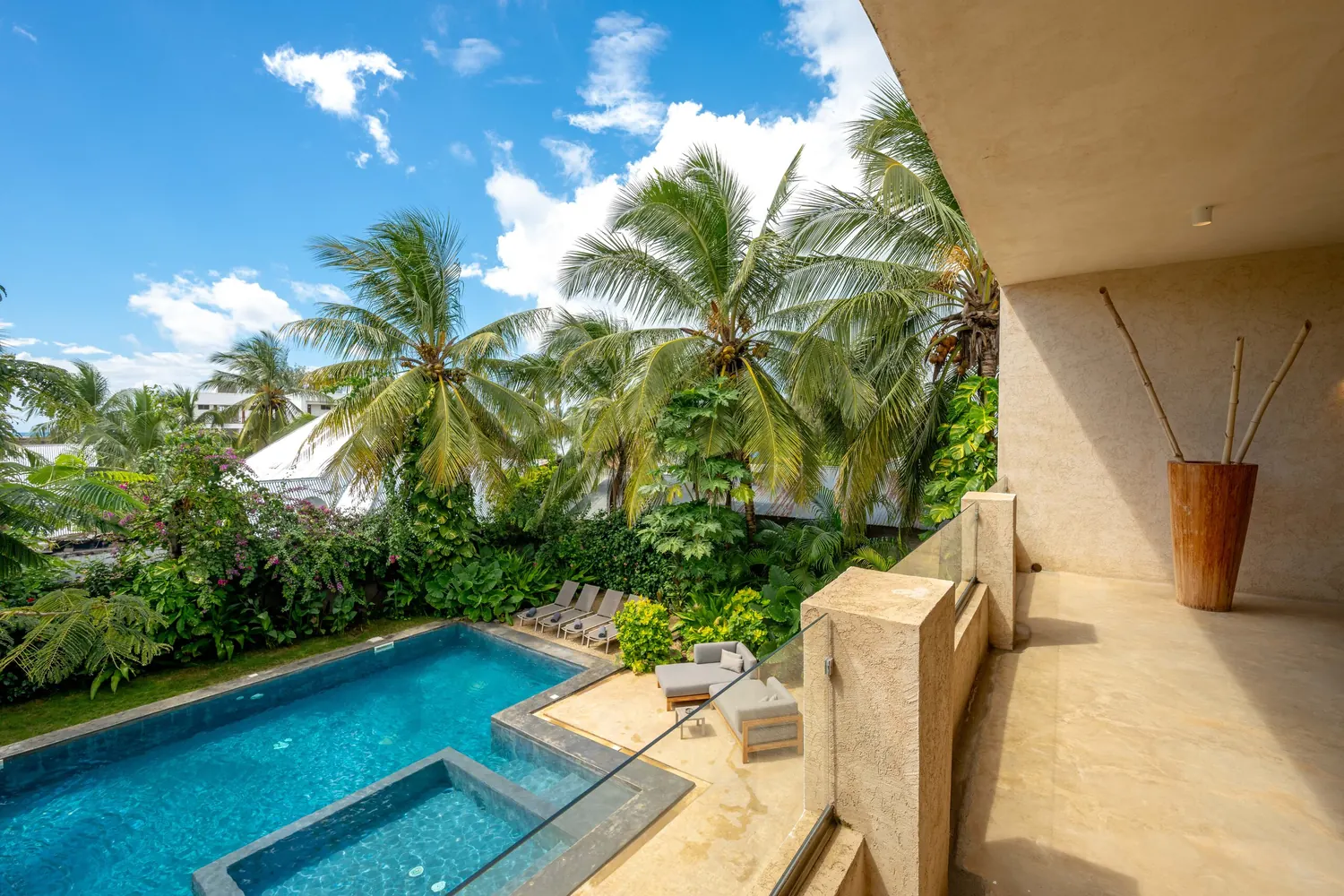 Pool seen from the villa terrace through the palms