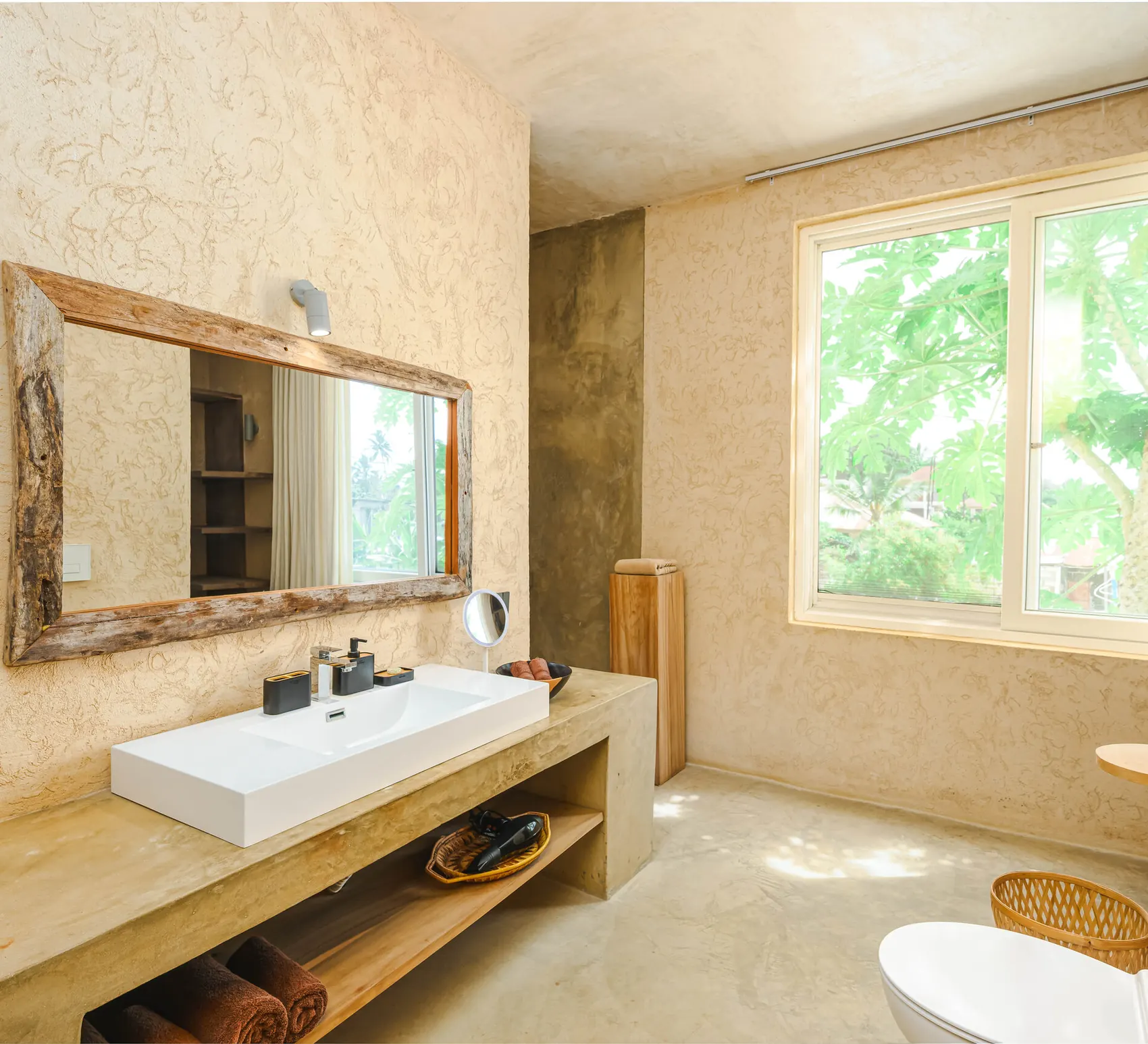 Ensuite bathroom at Villa Kokos with designer basin and wooden mirror